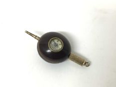 An unusual combination propelling pencil and compass mounted in a nut or seed, 2.5cm across