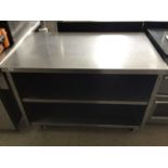 A freestanding stainless steel preparation bench, with two shelves under, on castors, 1200 mm