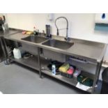 A stainless steel double bowl sink unit with pre-rinse flexi-hose tap and pair of taps, plus shelf