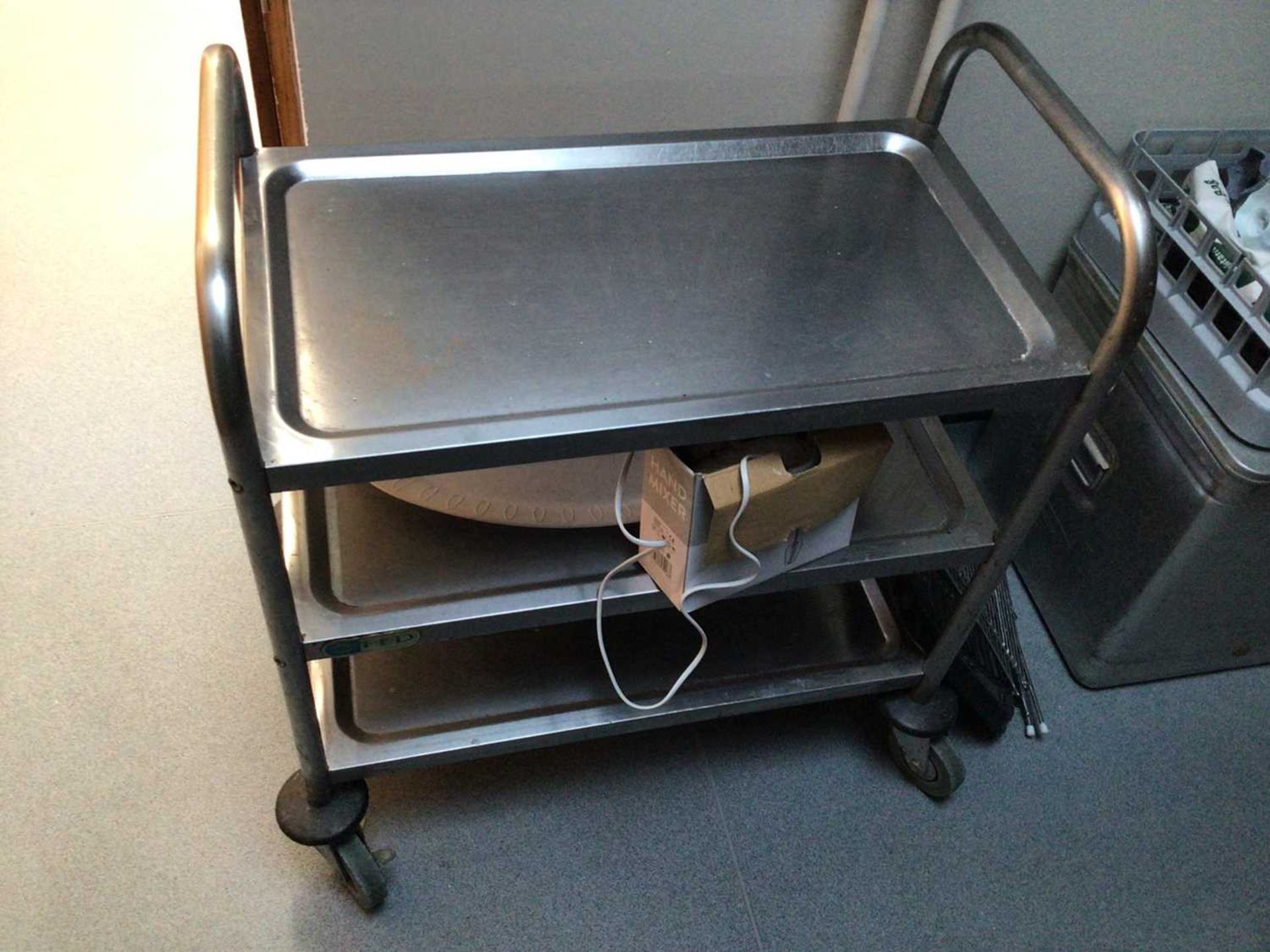 A stainless steel three tier tea trolley, on castors, 700 mm x 380 mm