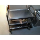 A stainless steel three tier tea trolley, on castors, 700 mm x 380 mm