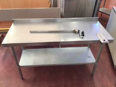 A wall mounted stainless steel preparation bench, with shelf under and fitted can opener, 1500 mm