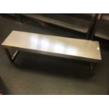A stainless steel shelf, on twin pedestals, 1160 mm