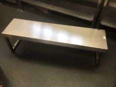 A stainless steel shelf, on twin pedestals, 1160 mm