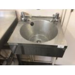 A Sissons stainless steel wash basin with taps