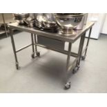 A stainless steel freestanding preparation bench, with drawer, on castors, 1200 mm