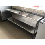 A Portland stainless steel double bowl sink unit, with two pairs of taps and draining board, laminat