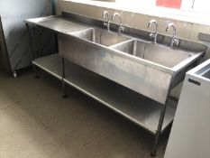 A Portland stainless steel double bowl sink unit, with two pairs of taps and draining board, laminat