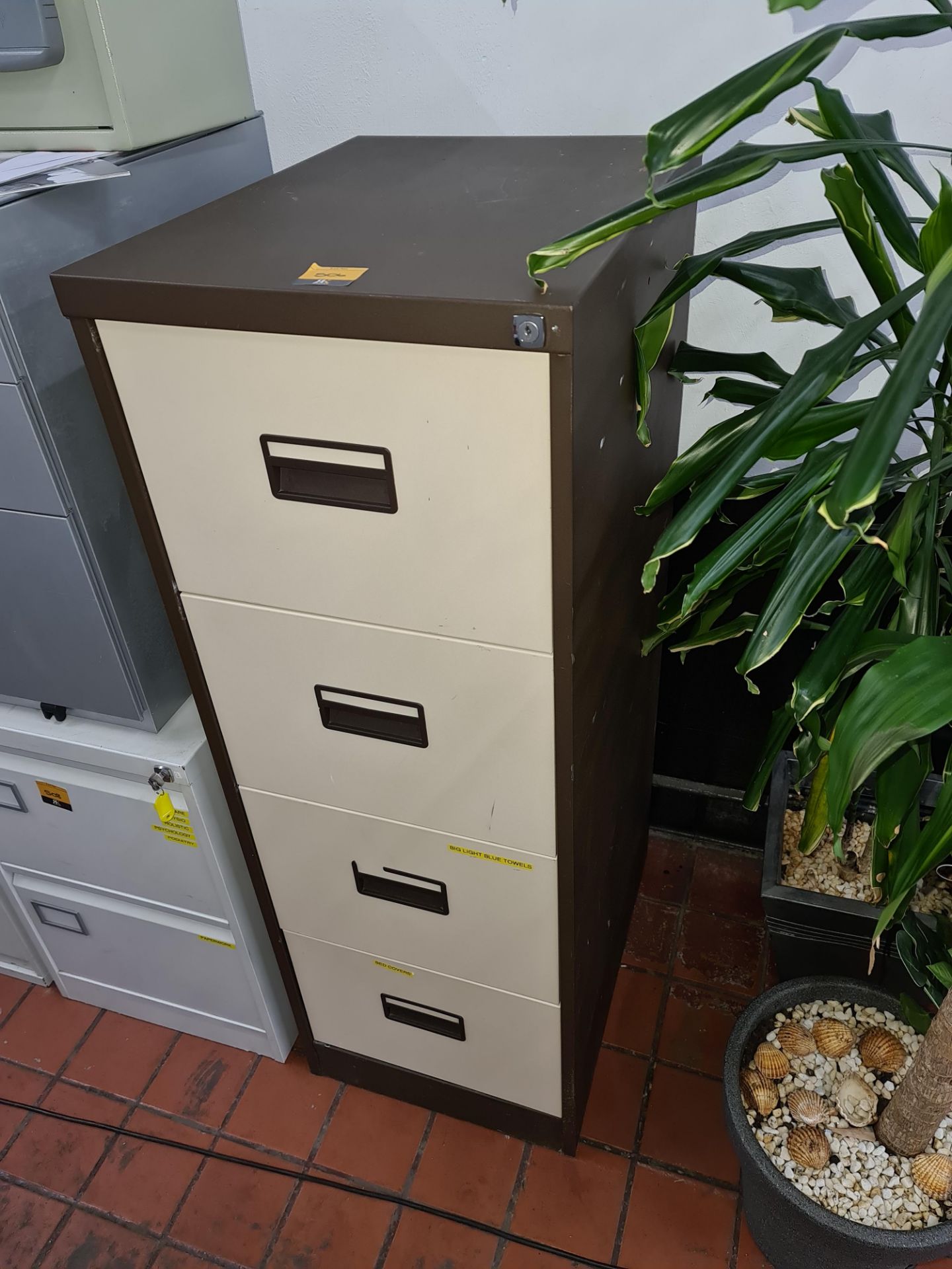 Brown metal 4-drawer filing cabinet