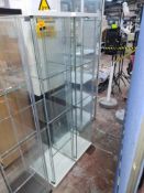 2 off glass display cabinets, one with some form of removable lighting. White plinths to top & botto