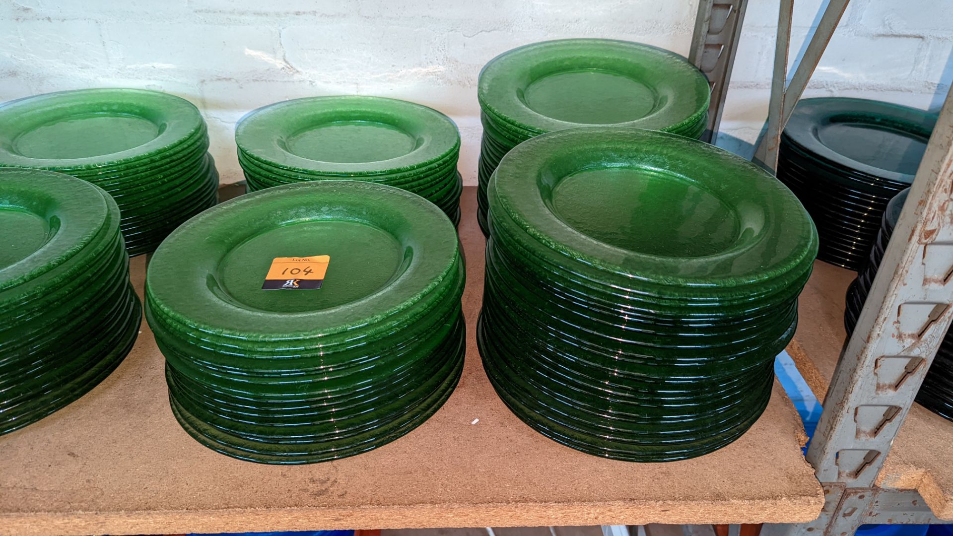 75 off green glass plates each measuring approximately 27cm diameter