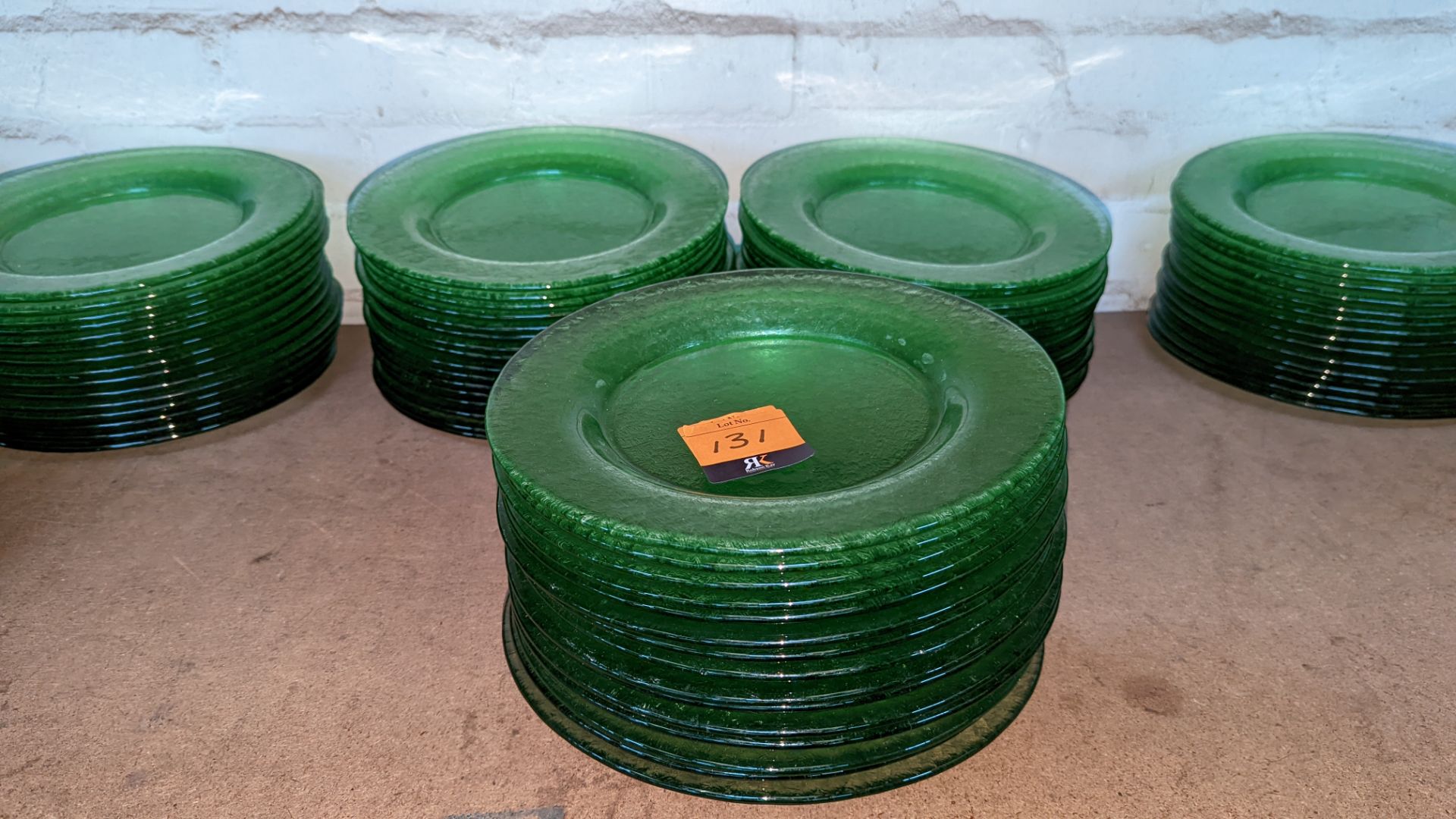 45 off green glass plates each approximately 275mm diameter (3 stacks)