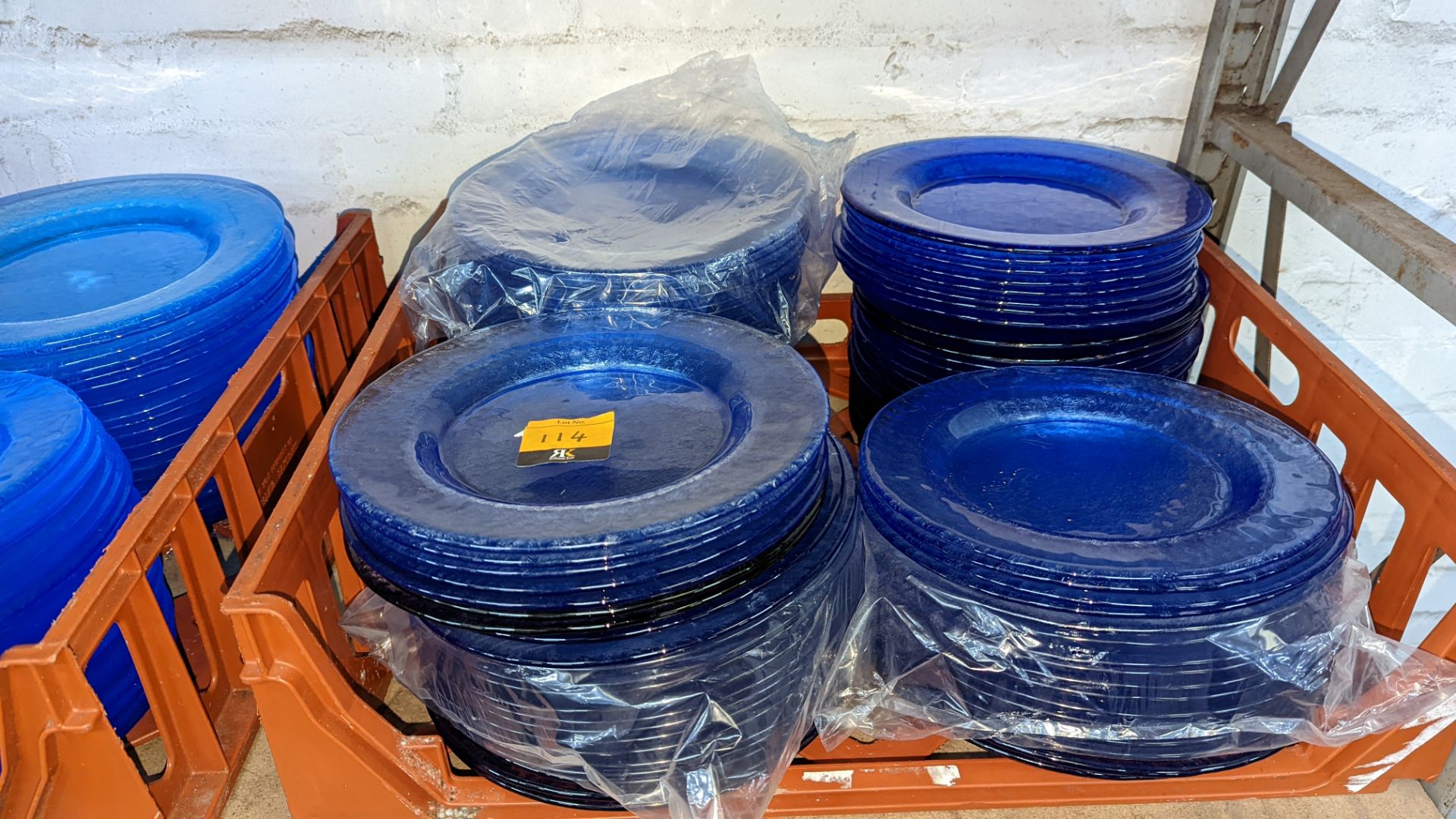 Approximately 90 blue glass plates, each approximately 26cm diameter. NB all of the plates are a da