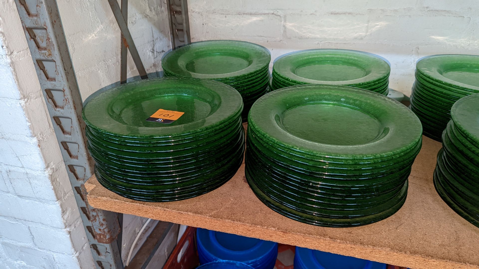 60 off green glass plates each measuring approximately 27cm diameter