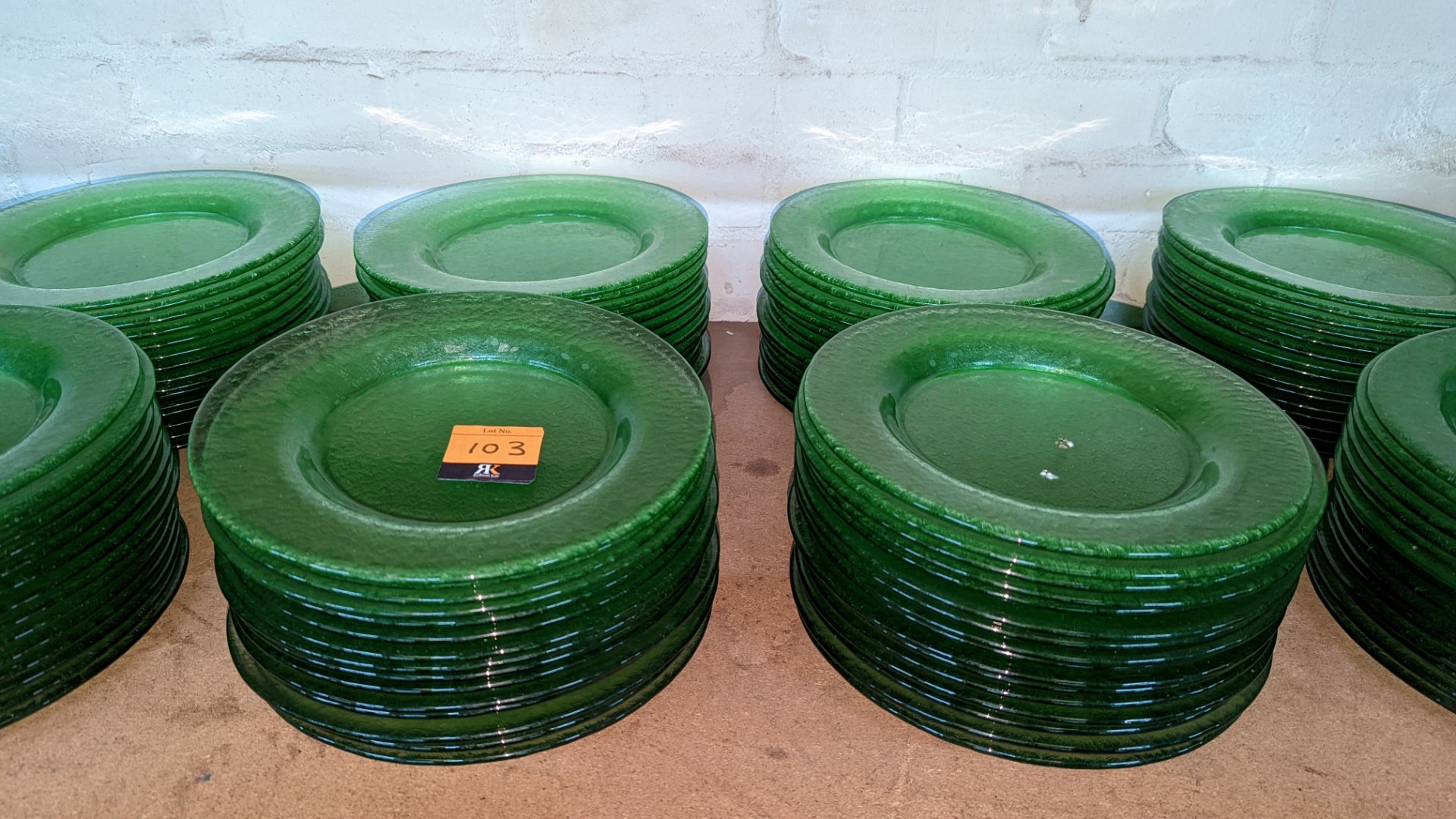 60 off green glass plates each measuring approximately 27cm diameter