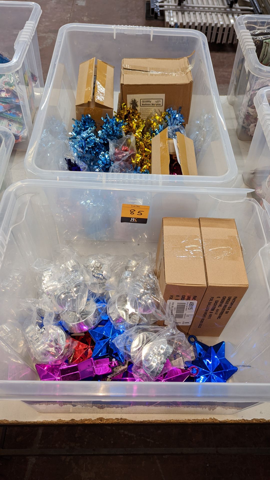 Contents of 2 crates of assorted balloon weights & similar - crates excluded