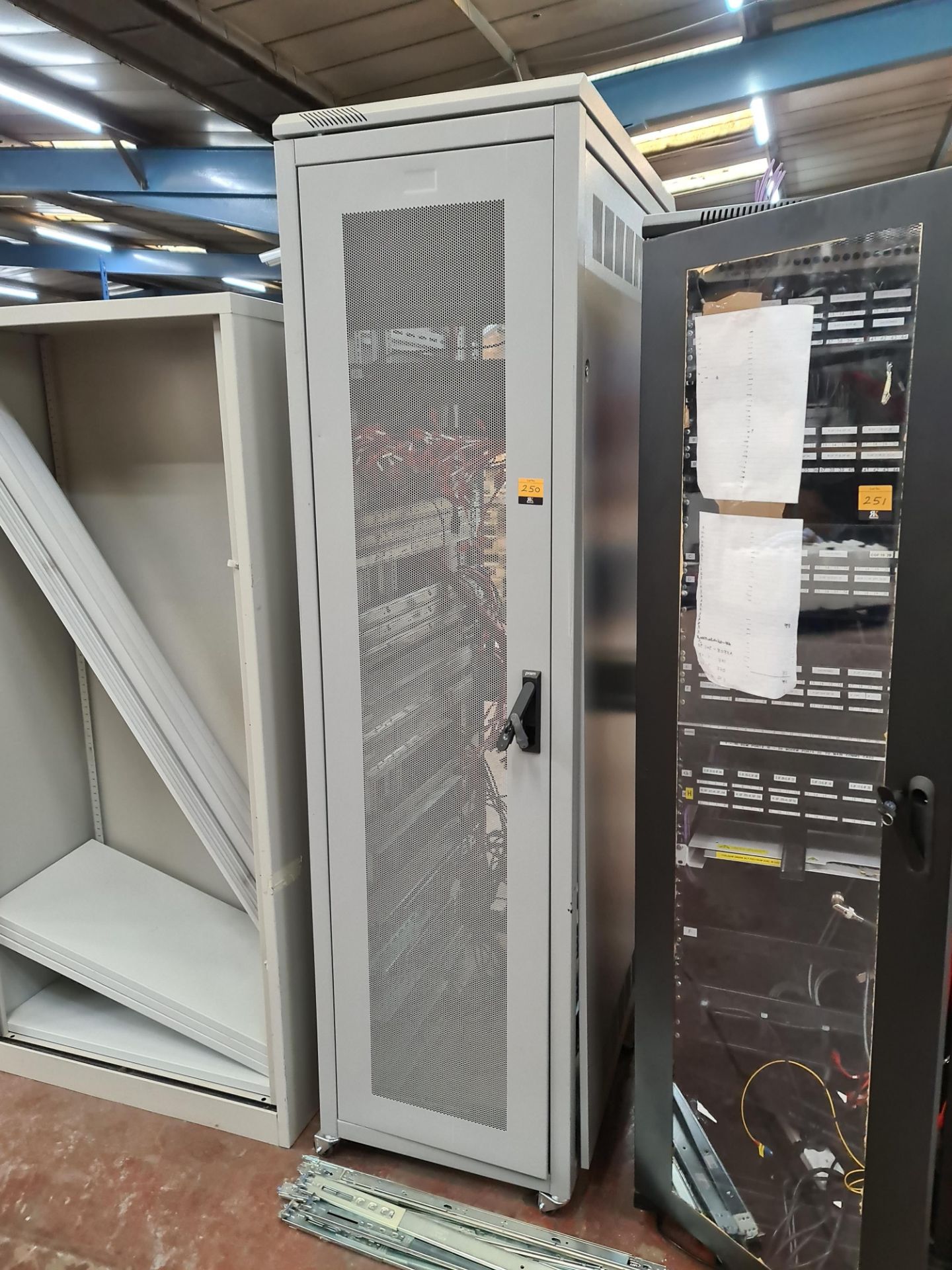 Prism server cabinet, including spare rails located in front of cabinet as can be seen in pictures.