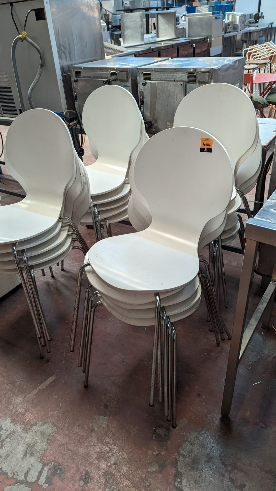 20 matching stacking chairs in white painted wood on chrome bases