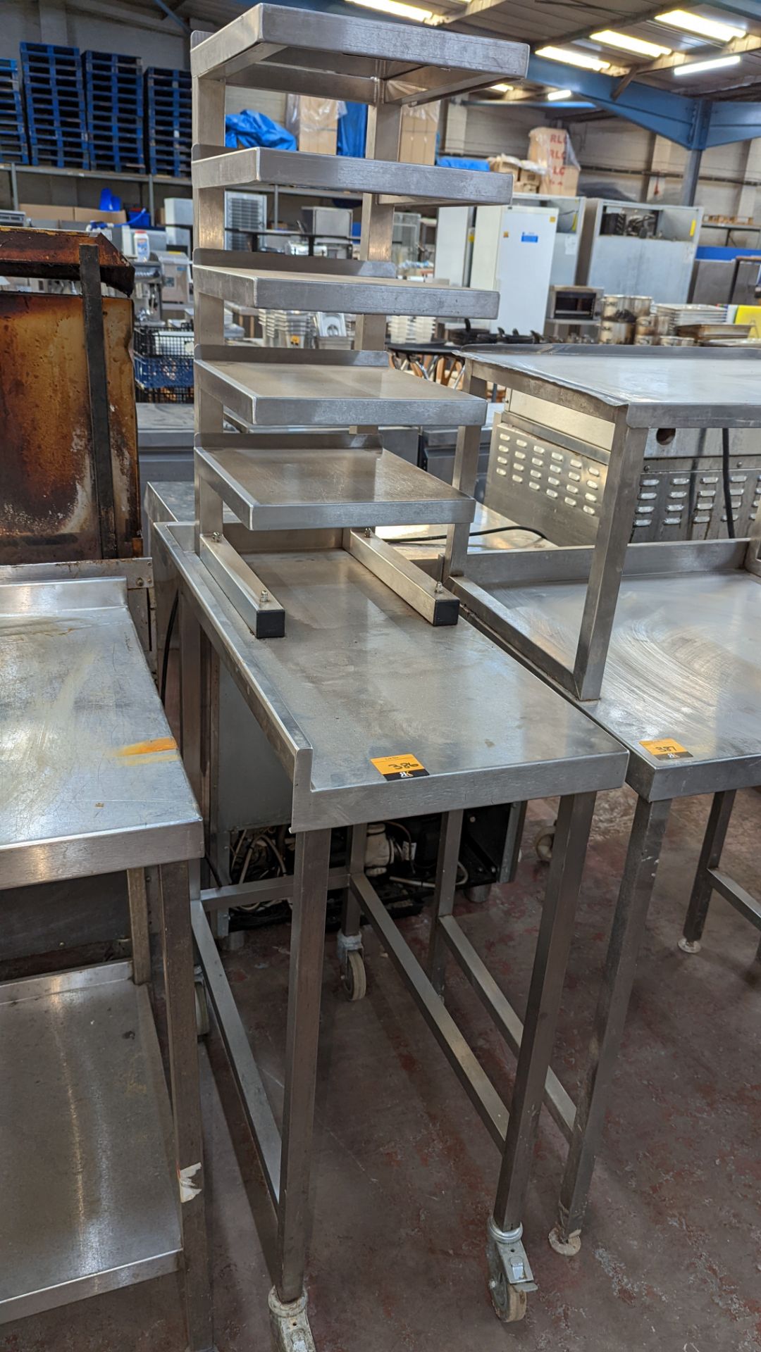Mobile stainless steel table incorporating 5 shelf system bolted to top of same