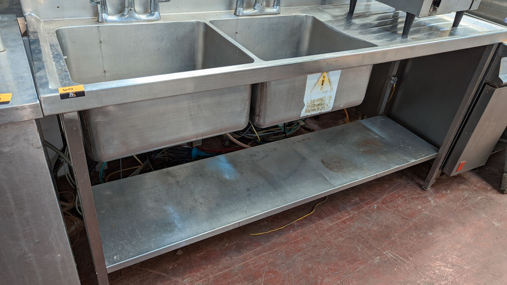 Stainless steel twin bowl sink arrangement incorporating mixer taps, drainer & shelf below