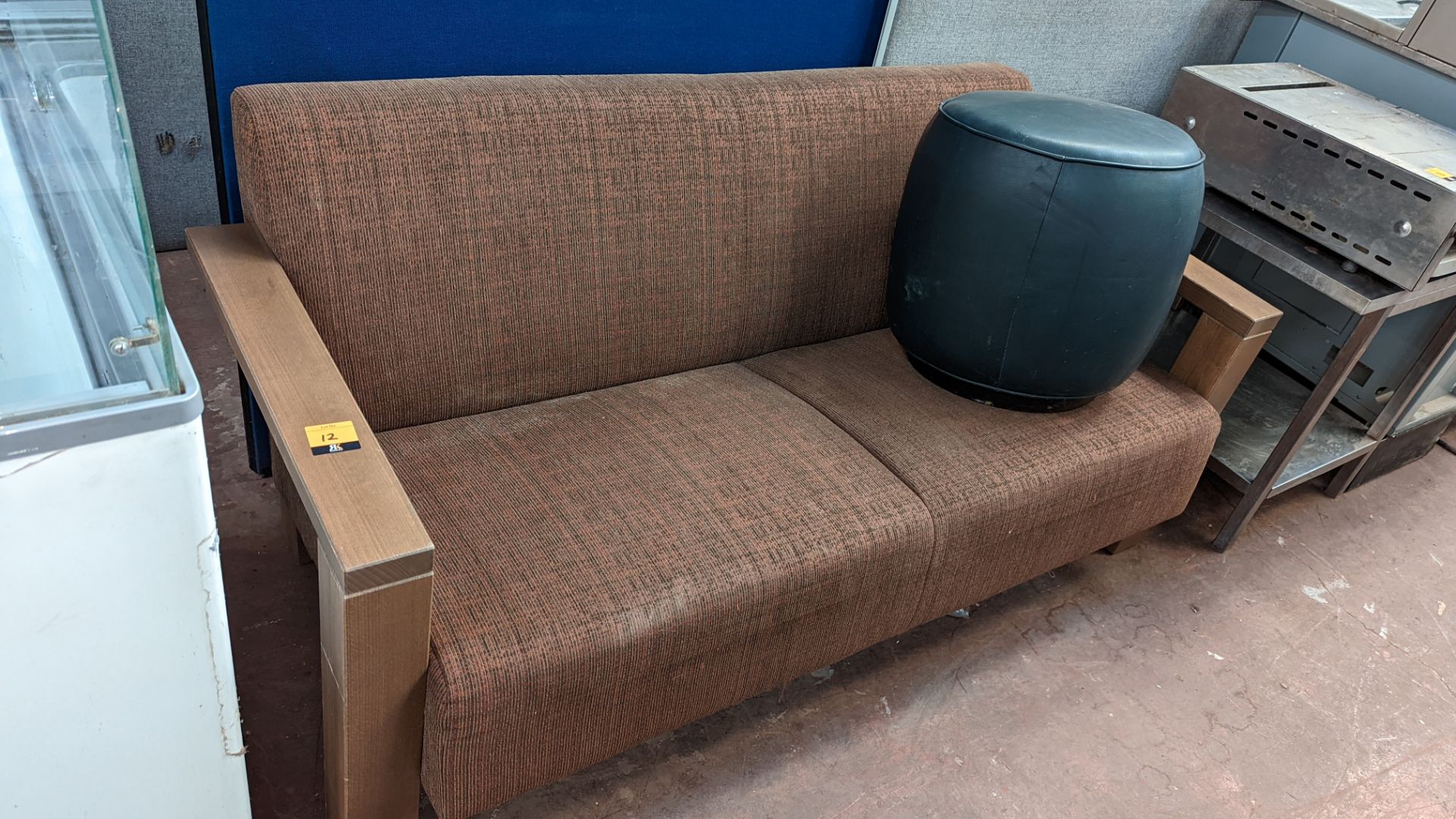 Upholstered sofa on wooden frame plus black pouffe/footstool