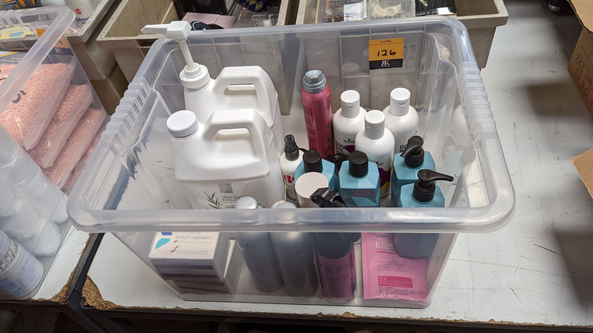 Contents of a crate of assorted shampoo & other products, some of which appear part-used/open - crat