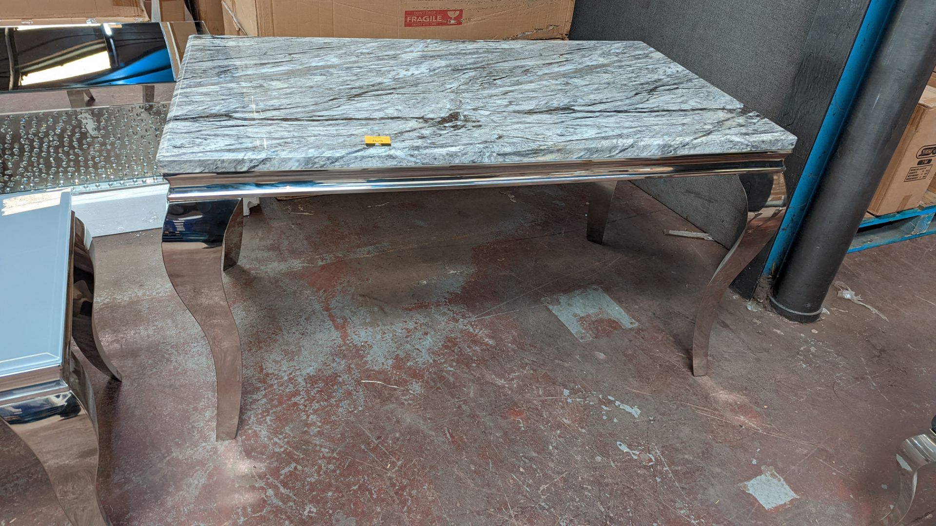 Dining table with what we assume is a marble top, on silver frame/legs. Table top measures circa 14