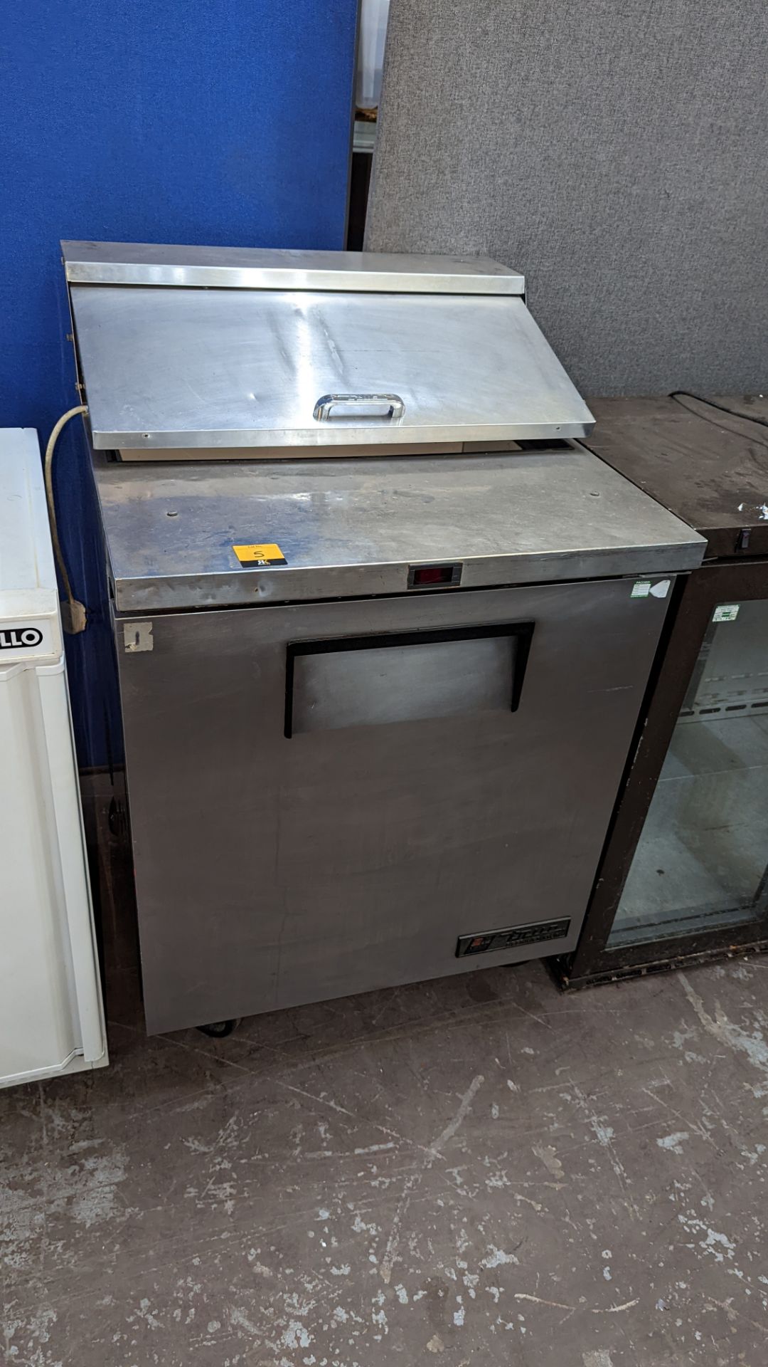 True Refrigeration stainless steel single door fridge with hinged top loading access as well as door