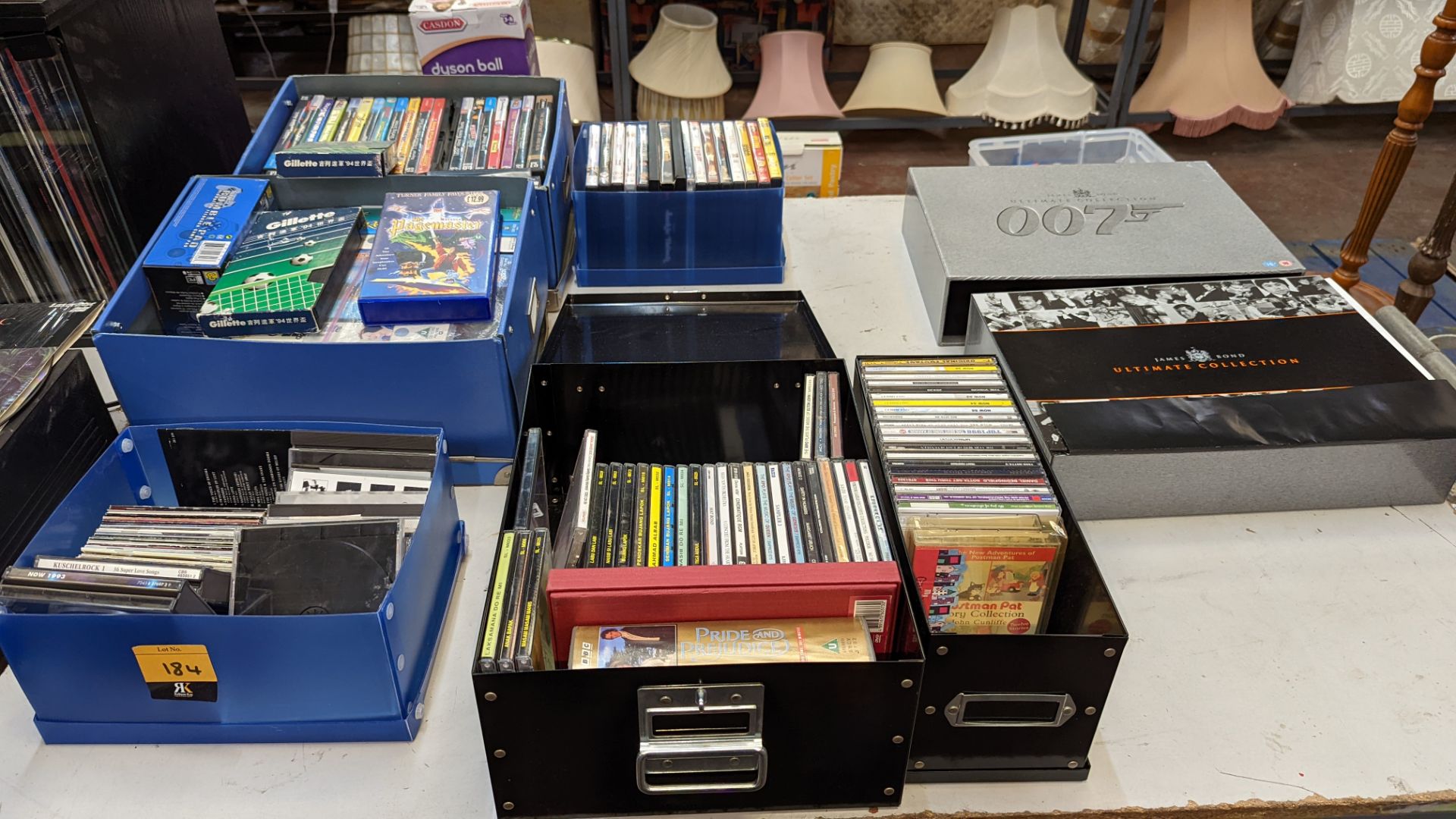 The contents of a table of audio-visual media comprising DVDs, VHS tapes, CDs & more. Includes Jame