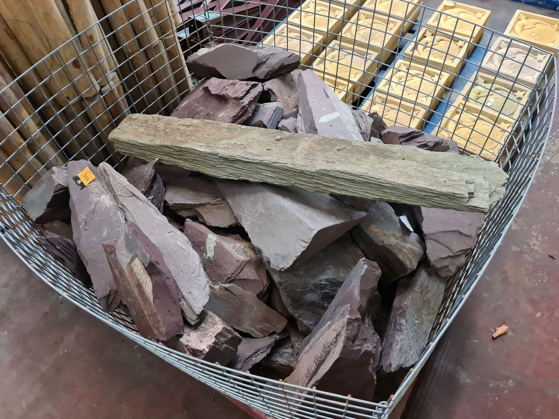 Large metal cage and contents of slate type material