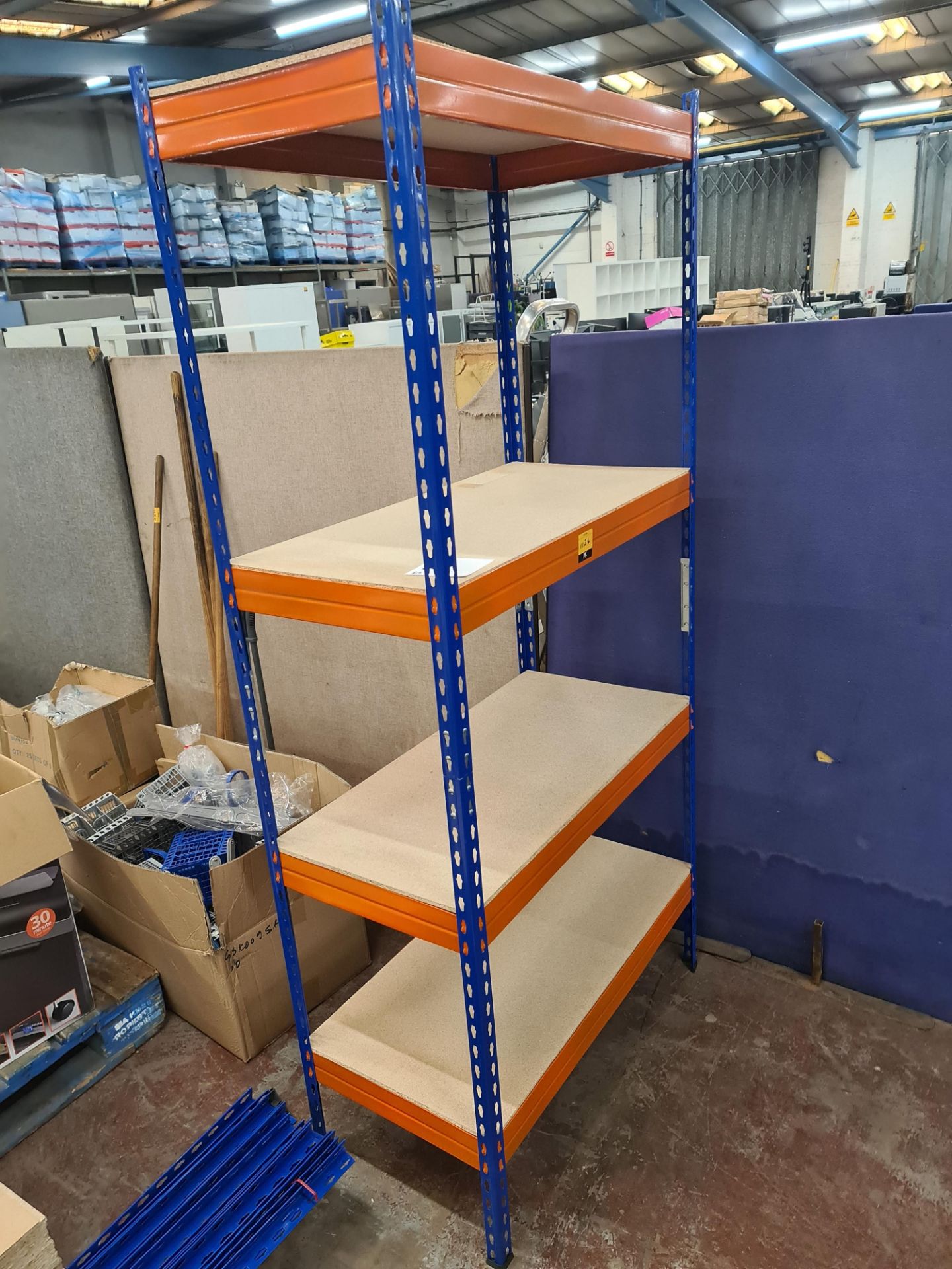 5 individual free standing bays of blue and orange racking, each with four shelves. One of the bays