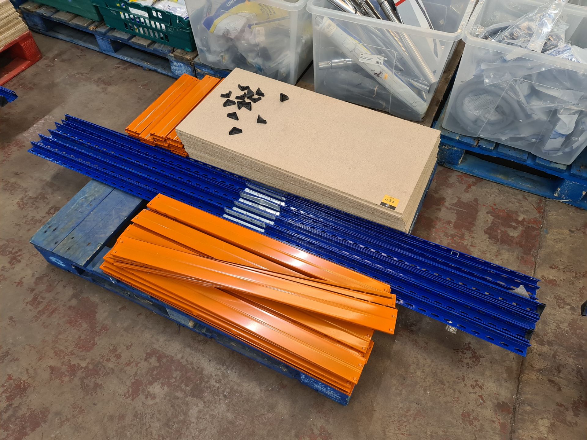 5 bays of blue and orange racking each with four shelves. All five bays have been disassembled and
