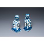 A pair of Dutch Delft blue and white seated dogs, 18th C.