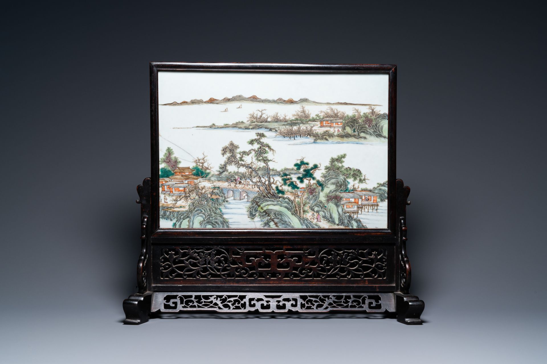 A Chinese rectangular famille rose 'landscape' plaque mounted in a wooden table screen, 19/20th C. - Image 2 of 12