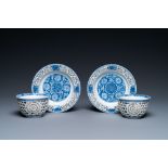 A pair of Chinese blue and white reticulated double-walled cups and saucers, Kangxi