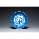 A Chinese ribbed blue and white dish with a scholar and his pupil, 19th C.