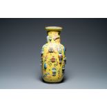 A Chinese yellow-ground famille rose rouleau vase with applied 'antiquities' design, 19th C.