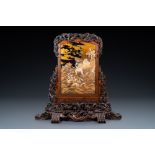 A large Japanese wooden screen with a central gilt-lacquered and ivory-inlaid panel, Meiji