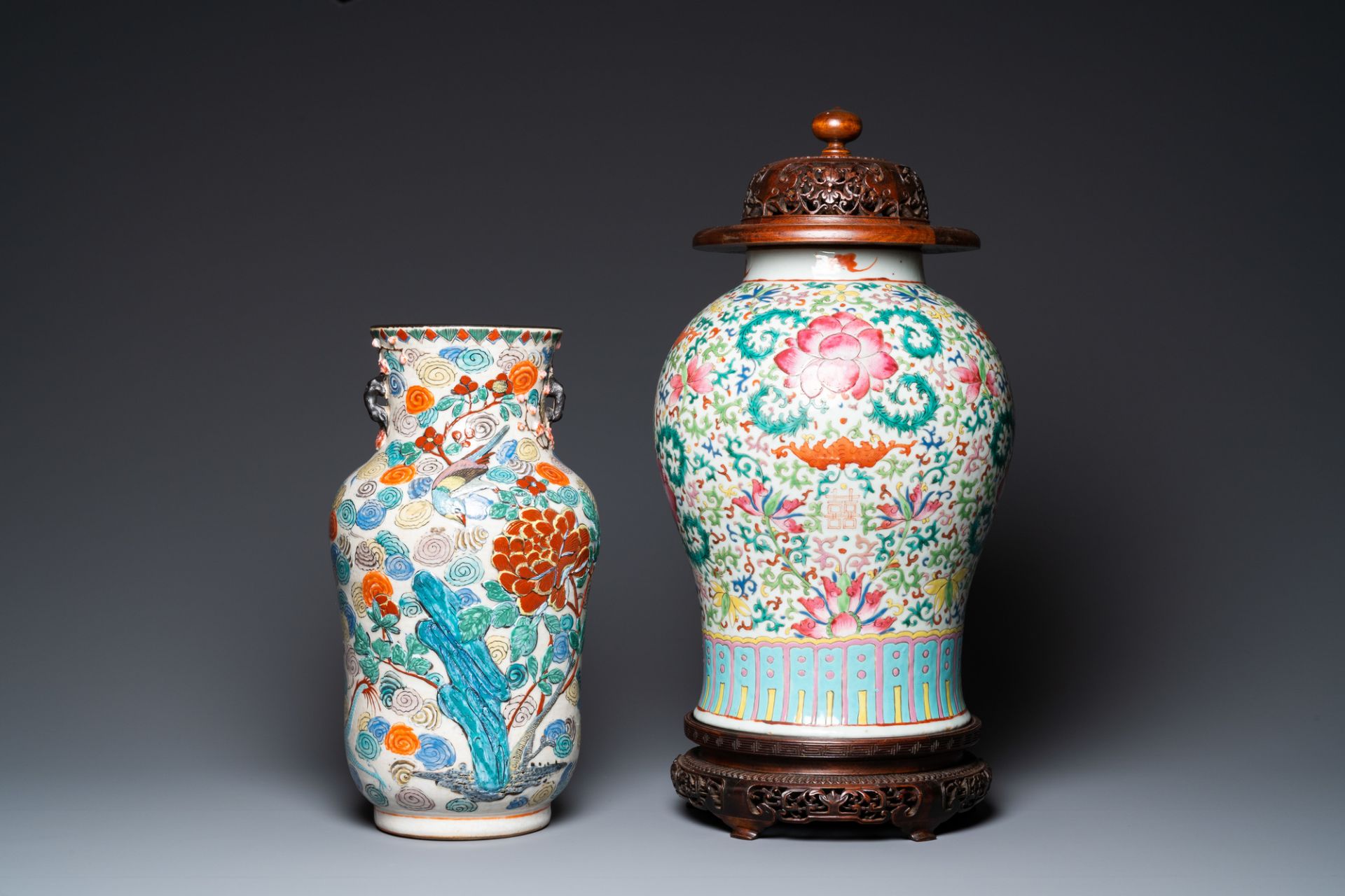 A Chinese famille verte vase and a famille rose vase with wooden cover and stand, 19th C.