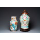 A Chinese famille verte vase and a famille rose vase with wooden cover and stand, 19th C.