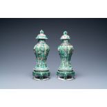 A pair of Chinese verte biscuit vases and covers on stands, Kangxi