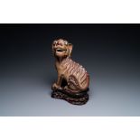 A Chinese Yixing stoneware dog on wooden stand, 19th C