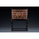 A tortoise veneer, gilt copper, ebony and ebonised wooden cabinet on stand with mirrored interior, A