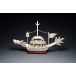 A Chinese carved ivory dragon boat on wooden stand, 19th C.