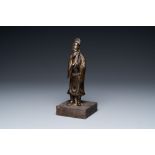 A Chinese partly gilt bronze figure of a scholar, Ming