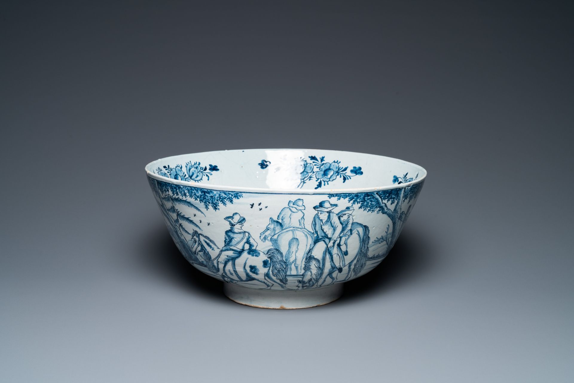 A large Dutch Delft blue and white bowl with shepherds on horsebacks, 18th C.