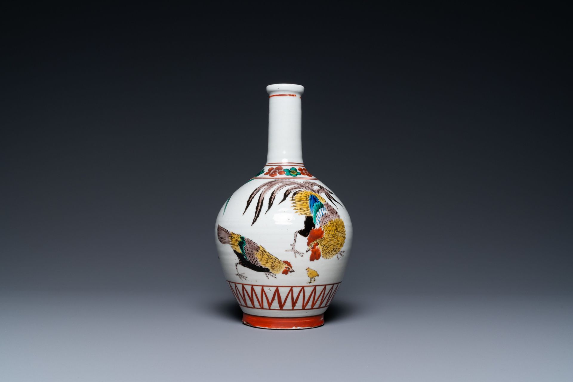 A Japanese Ko-Imari bottle vase in Ko-Kutani-style with a rooster, a hen and their chick, probably E