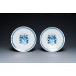 A pair of Dutch Delft blue and white armorial dishes, late 17th C.