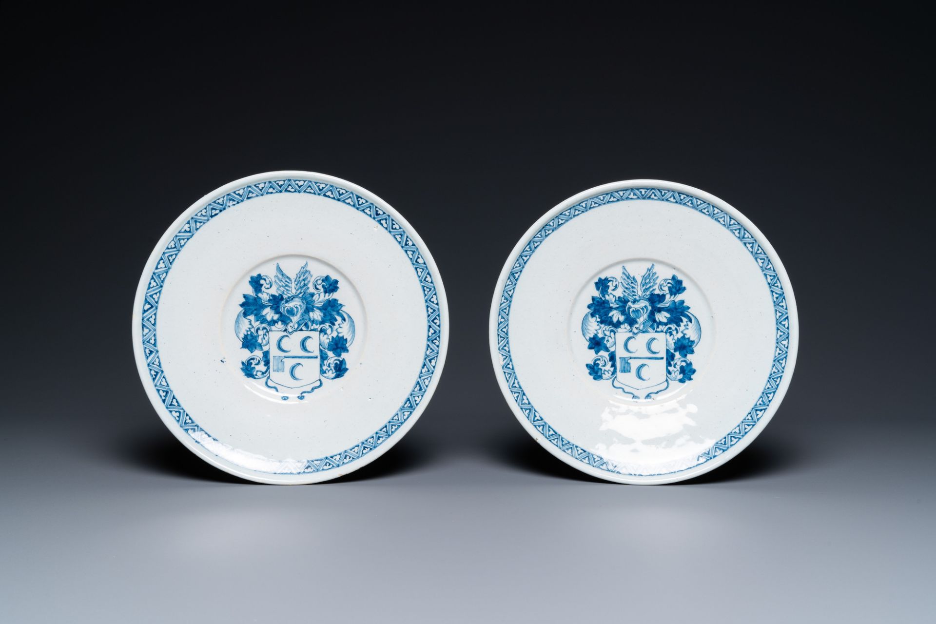 A pair of Dutch Delft blue and white armorial dishes, late 17th C.