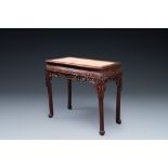 A Chinese rectangular carved wooden table with marble top, 19th C.